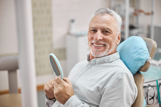 closeup of man smiling in dental chair 